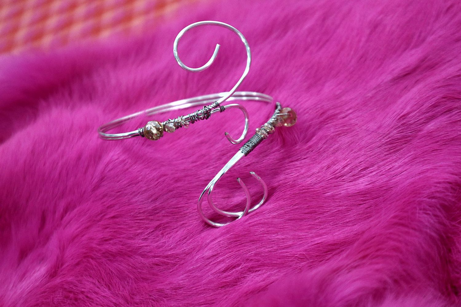 Silver-coloured swirl wire arm cuff